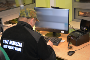 Funkcjonariusz SG prowadzi kontrolę graniczną
